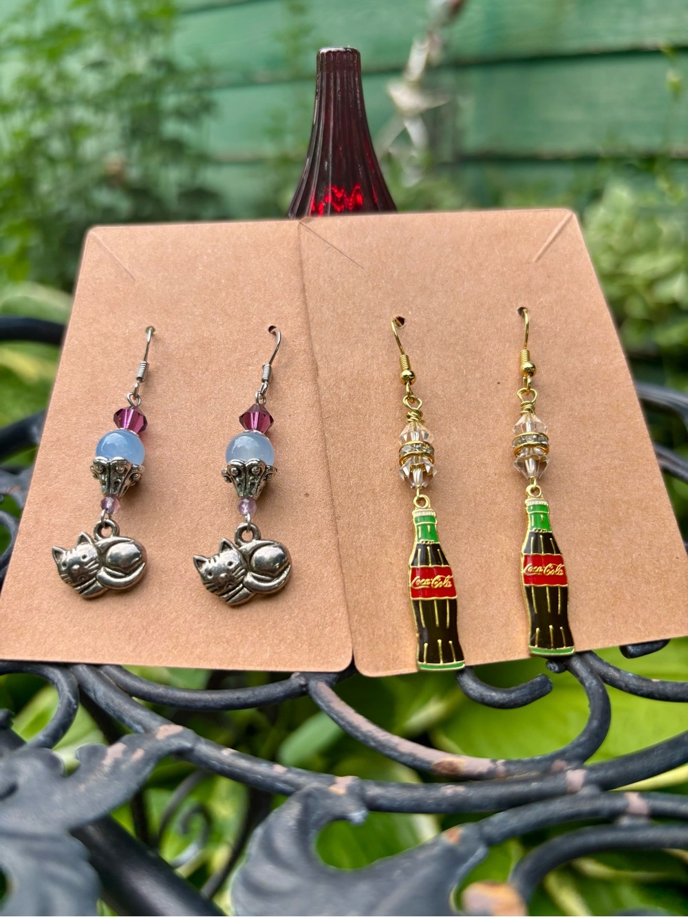 Coca-Cola and Cat earrings.
